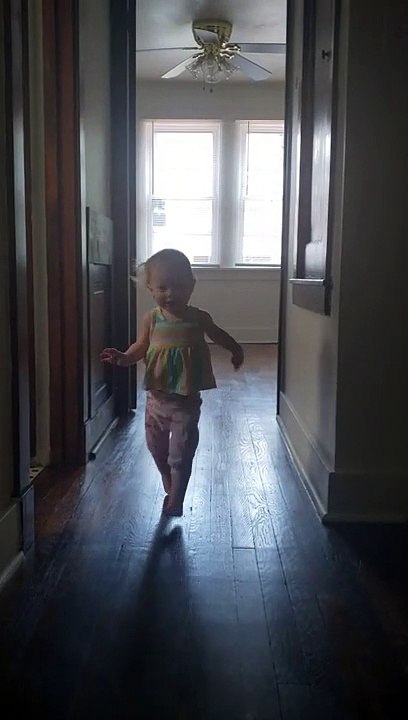 Daughter Running and Giggling Around the New Place