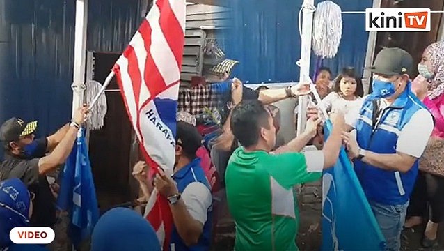 BN Kukusan candidate's campaign team takes down rival's flags during walkabout