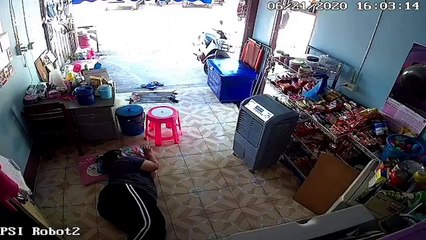 Wild monitor lizard runs across woman while she lies down relaxing