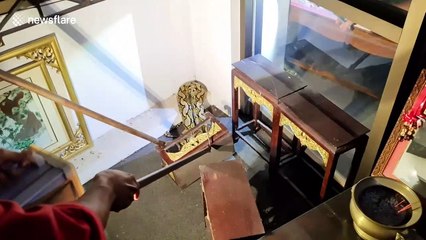 Huge python caught in Buddhist prayer room