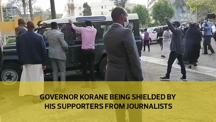 Governor Korane being shielded by his supporters from Journalists