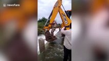 Police in India use digger to rescue pup stranded due to overflowing reservoir