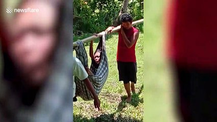 Filipino family carry sick mother in makeshift hammock to reach hospital