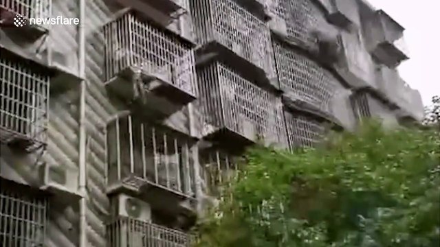 Chinese man holds up 4-year-old boy dangling from window before firefighters arrive