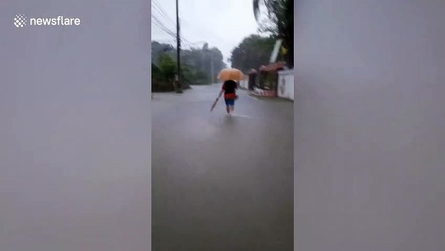 Residents wade through flooded streets as Typhoon Noul approaches northern Thailand