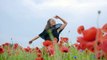 mixkit-girl-dancing-happily-in-a-field-of-flowers-4702