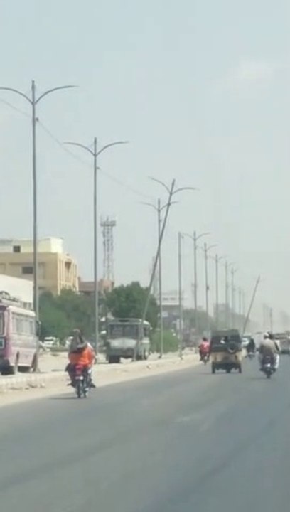 K-Electric titled pole hanging on the road