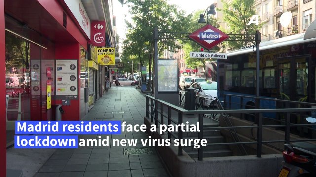 Police officers control cars as Madrid begins partial virus lockdown