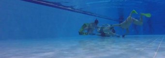 People Play Underwater Hockey Match in Swimming Pool