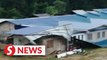 Strong winds lash remote longhouse, tearing roof and awnings