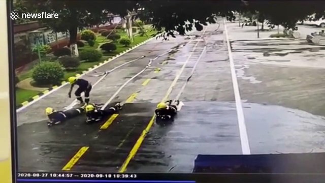 Chinese firefighters left soaked after colleague loses control of water hose during training