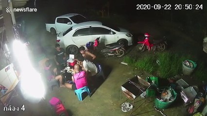Chilling moment deadly snake creeps up on men having BBQ in Thailand
