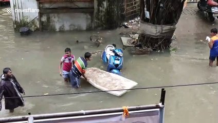 Kids play in flooded streets of Mumbai during torrential monsoon