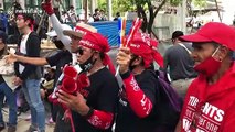 Protesters gather outside Parliament House in Bangkok as King visits country