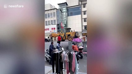 Man uses digger to smash police car in central China