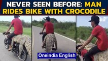 Man ties crocodile on bike, sits on top : Video draws ire on social media|Oneindia News