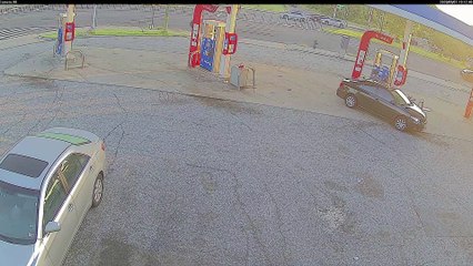Trash Truck Tire Meets Car Caboose in Gas Station Conundrum