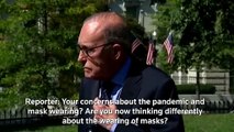 Kudlow puts on a mask at the request of reporters