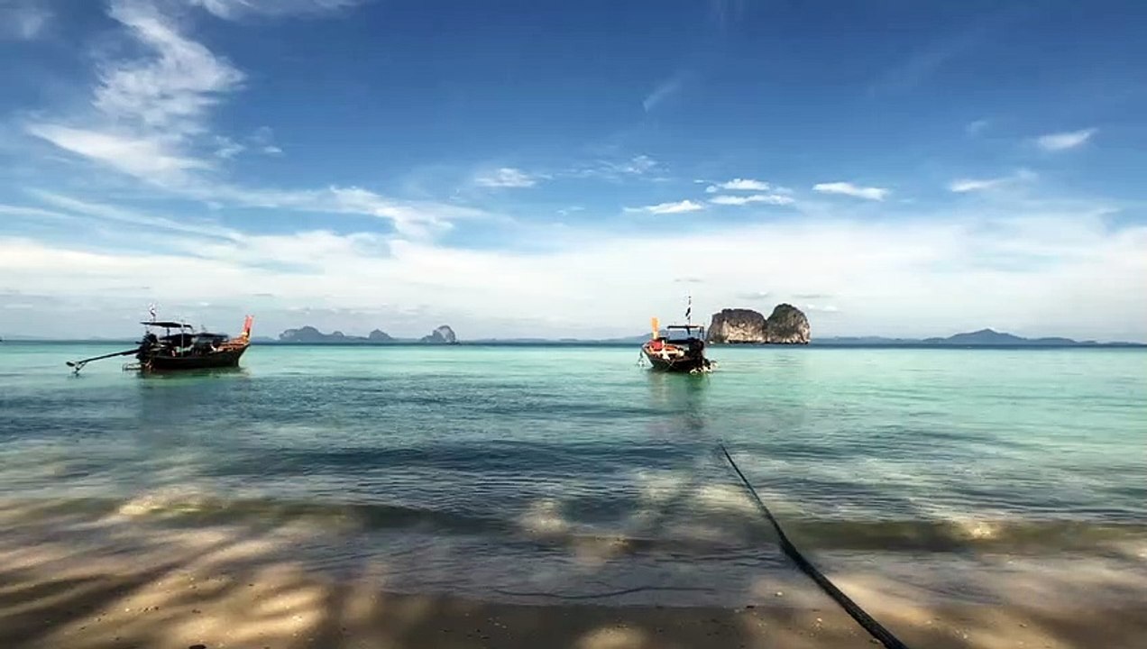 Boats floating at the tropical seashore Aerial shot over a sandy coastline natural beautiful royalty Free Stock no copyright video Free for commercial use dron dron aerial view