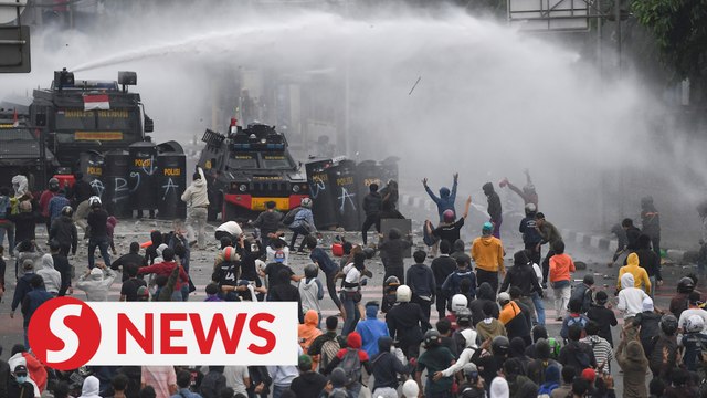 Police and demonstrators clash in Indonesia over labour law protest