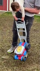 Little Girl Grips Onto Lawnmower Toy Tightly