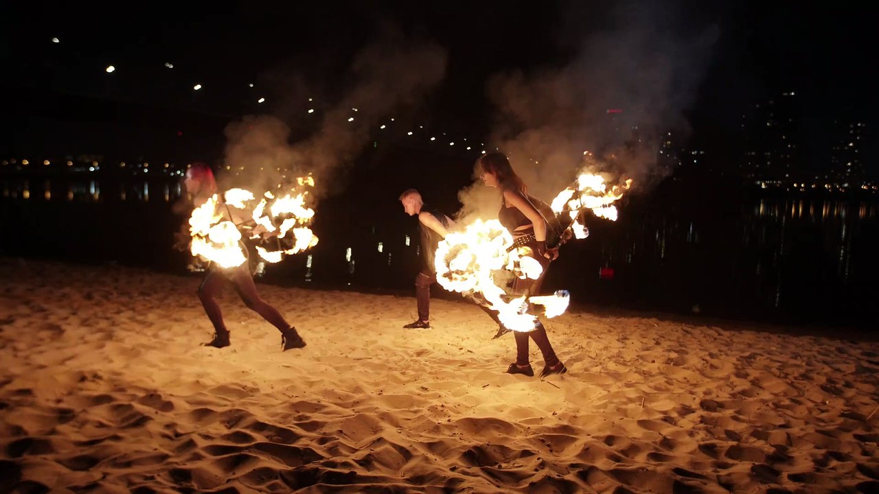 mixkit-fire-jugglers-on-a-beach-4555