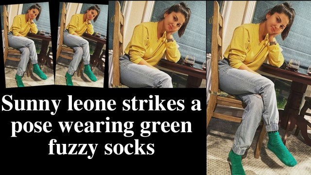 Sunny leone strikes a pose wearing green fuzzy socks