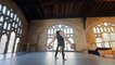 Performer Shuffles Metal Balls Between Legs While Doing Handstand