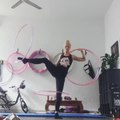 Woman Balances On One Leg And Spins Hula Hoops Around Limbs