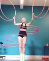 Woman Spins Multiple Hula Hoops Simultaneously Around Waist And Arms