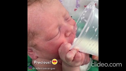 Newborn baby drinks milk from a cup all by himself!