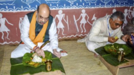 Shah eats lunch at the house of a Matua Community member