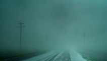 Storm chasers back up from possible tornado crossing road