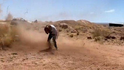 Man runs straight into approaching dust devil