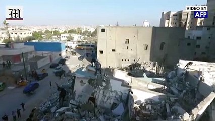Palestinian youths practice parkour on rubble of Gaza's al-Jalaa tower