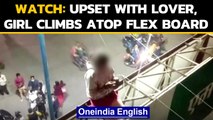 Girl climbs atop flex board after being upset with lover in Indore: Watch the Video | Oneindia News