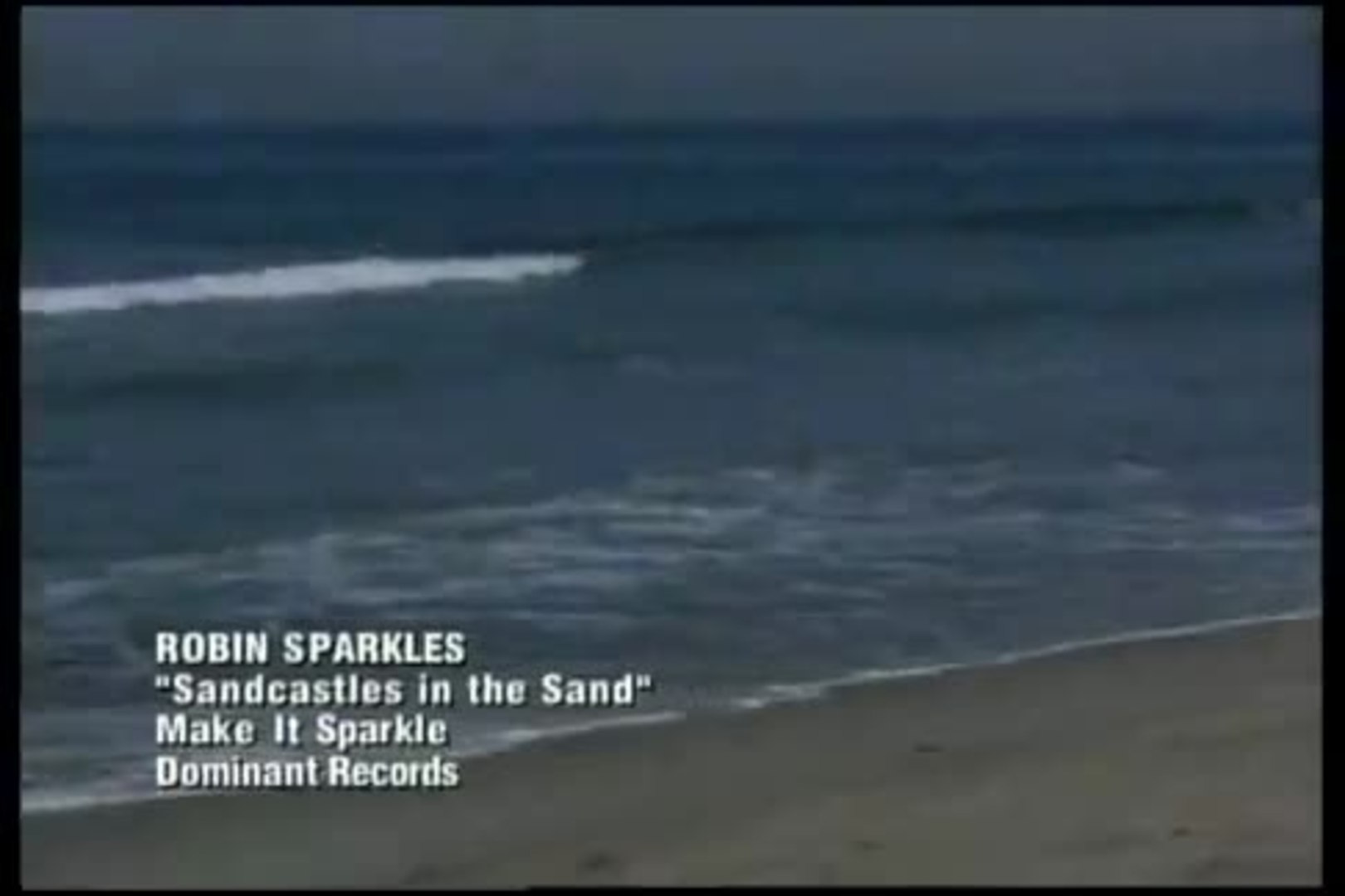 Robin sparkles sandcastles in the sand