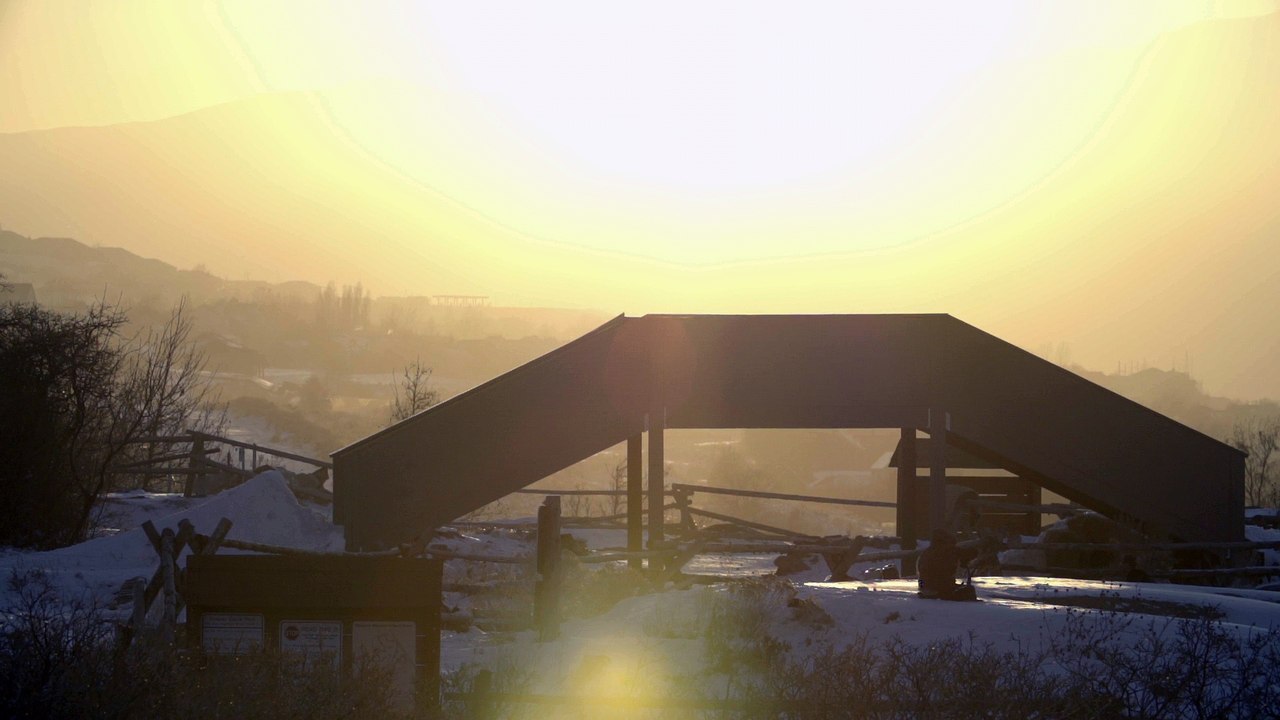 Person Falls on Back in Snow After Failing Skiing Trick on Ramp