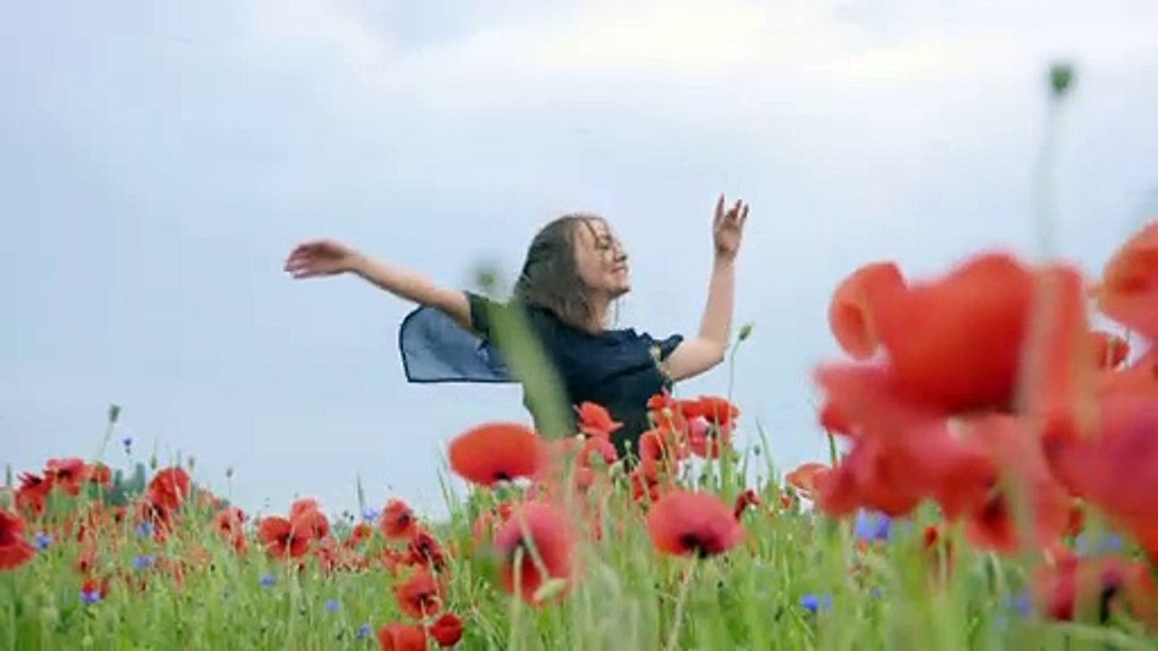 girl-dancing-happily-in-a-field-of-flowers