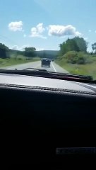 SUV Veers Off Road into Hay Trailer