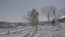 Skier Displays Talent by Skiing Down Rail
