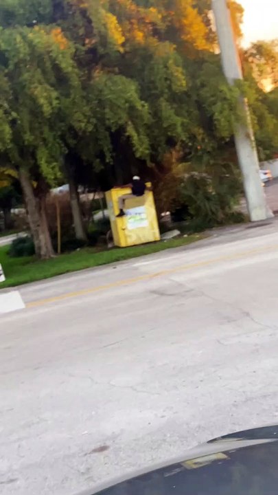 Man Climbs into Donation Bin