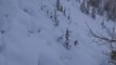 Guy Jumps And Skis Down Snowy Mountain