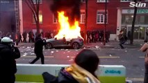 Riots in Paris as masked mob hurl Molotov cocktails and torch cars over new police filming law