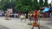 Bull on street runs after priest clad in orange, red _ Pedestrian gets knocked down by raging bull