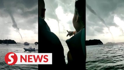 Thrillseekers sail towards waterspout in Singapore