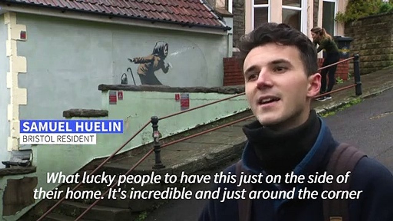 Sneezing woman artwork by British artist Banksy appears on Bristol house