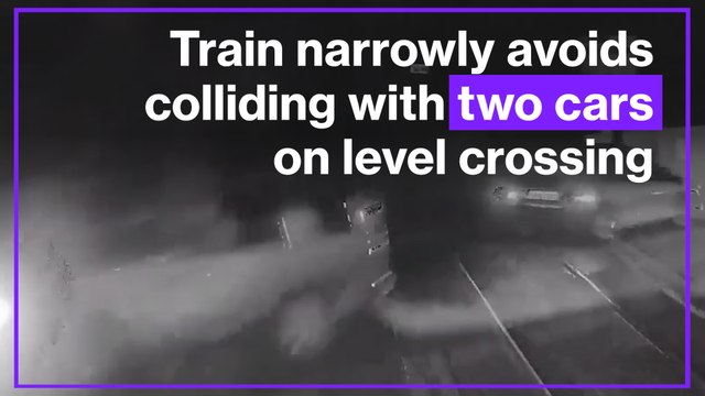 Shocking video shows moment train narrowly avoided colliding with two cars on level crossing