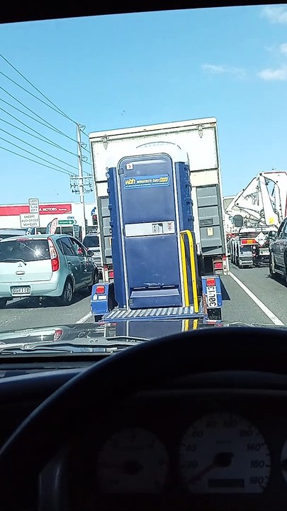 Using a Portable Toilet Being Towed in Traffic