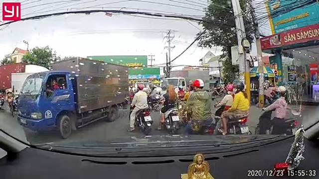 Truck Stops on Top of Motorcycle in Busy Intersection